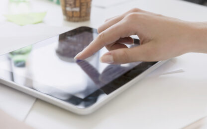 Germany, Bavaria, Munich, Close-up of womans hand using digital tablet